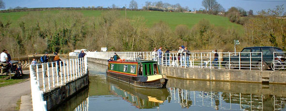 Canal boat leaving Avoncliff Aqueduct, Wiltshire by P L Chadwick